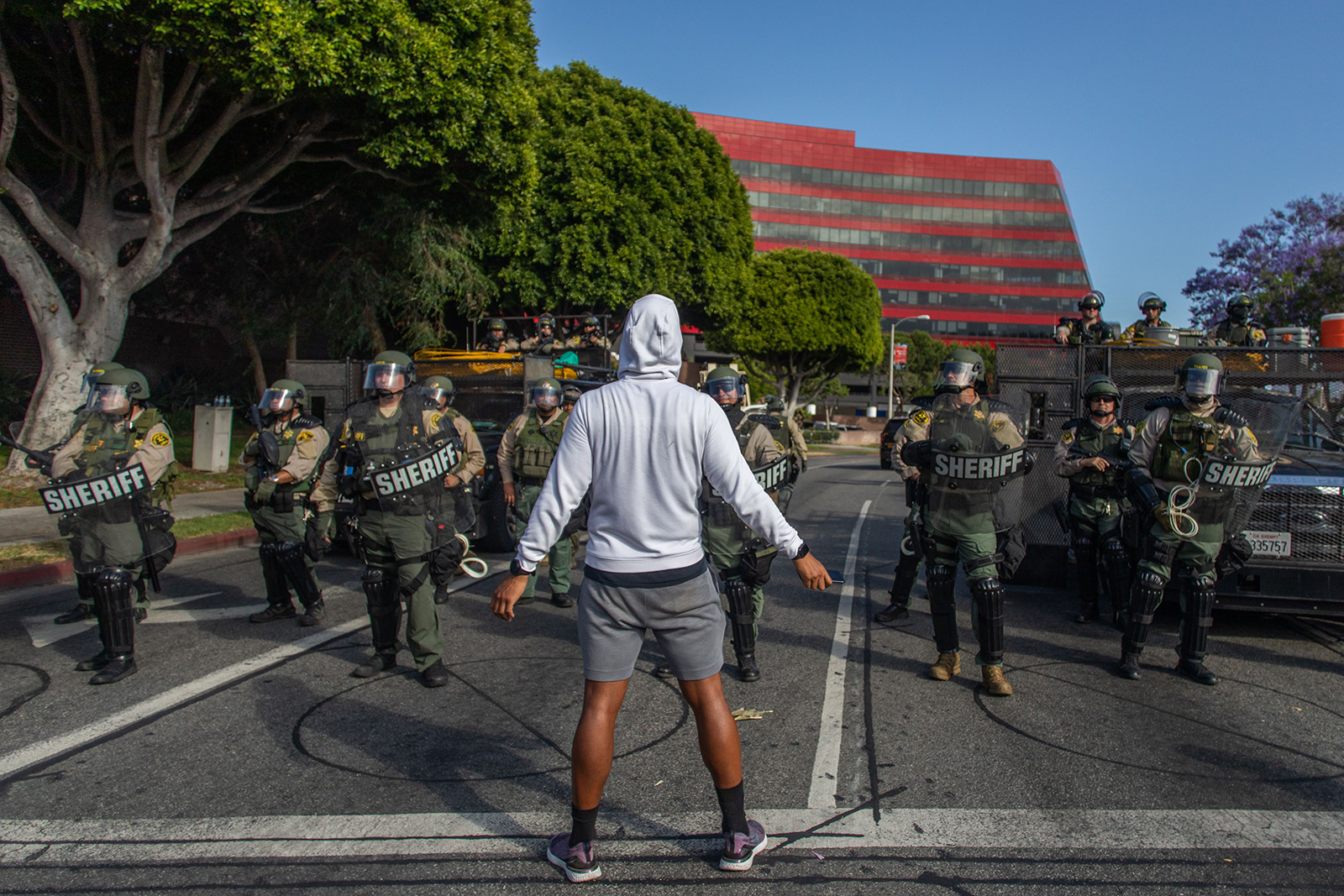 A protester stands in front of West Hollywood Police Police during a peaceful protest against police brutality and racism, in West Hollywood, California on June 6.