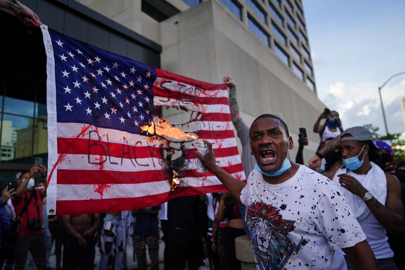 Demonstrators burn a flag outside the CNN Center on May 29, in Atlanta, Georgia. 