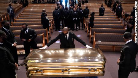 Joe Biden and Reverend Al Sharpton make notes at George Floyd's funeral in Houston